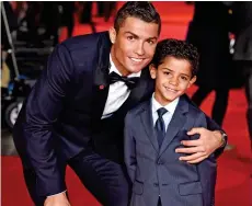  ??  ?? Proud father: With Cristiano Ronaldo Jr, seven