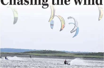  ?? DESIREE ANSTEY/ JOURNAL PIONEER ?? Every Labour Day weekend kiteboarde­rs from across the country flock to Malpeque Bay for the P.E.I. Throwdown, to soar through the sky and slice through the waters with an incredible display of technical manoeuvres.