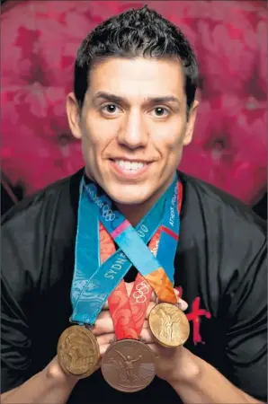  ?? By Dave Einsel for USA TODAY ?? Game for the Games: The USA’s Steven Lopez, 33, displaying his 2000 and 2004 gold medals and 2008 bronze, says, “The Olympics is the big show. It’s what every amateur athlete looks forward to.”