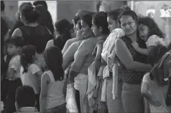  ?? GENARO MOLINA/LOS ANGELES TIMES FILE PHOTOGRAPH ?? A mother comforts her crying child while joining over 200 asylum seekers in the parking lot of an immigratio­n check-point in Nuevo Laredo, Mexico on Aug. 1. The U.S. is preparing to send asylum seekers to Honduras.