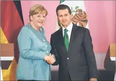  ??  ?? Merkel and Pena Nieto shake hands at the Palacio Nacional in Mexico City. — AFP photo