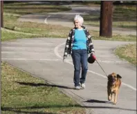  ?? The Sentinel-Record/Richard Rasmussen ?? OUT FOR A STROLL: Melba Templeton, of Hot Springs, walks her dog, Tessie, Wednesday on the Hot Springs Creek Greenway Trail.