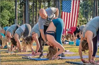  ?? WOUNDED WARRIOR PROJECT ?? Dan Nevins teaches a yoga class in 2015 at the Freedom Festival in North Carolina.