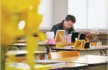  ?? Courtesy of Cine Sopa ?? Yoo Gyung-geun, a bereaved father who lost a daughter in the 2014 Sewol ferry tragedy, sits in her seat at Danwon High School in Ansan, Gyeonggi Province, in this scene from the film “Life Goes On.”