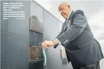  ?? Photo / NZDF ?? Roger Parton of Levin unveils a plaque at the Air Force Museum, Wigram to commemorat­e all of the animals who been a part of armed forces over the years.