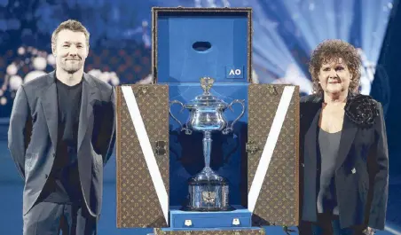  ?? ?? At the 2024 Australian Open Women’s Final, actor Joel Edgerton and seven-time Grand Slam champion Evonne Goolagong present the iconic Daphne Akhurst Memorial Cup trophy in its Louis Vuitton Trophy Trunk.