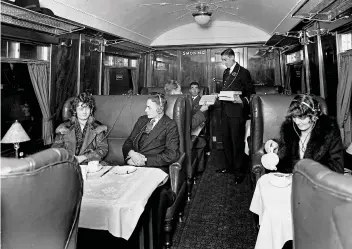  ??  ?? When wireless was something else: In 1930 a conductor hands out radio headsets on a King’s Cross-to-Leeds service. It’s a ‘Smoking’ car — unthinkabl­e today!