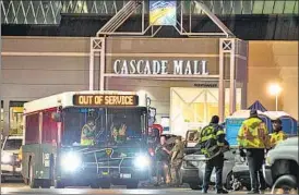  ?? AP ?? Police officials gather outside Cascade Mall in Burlington, Washington, where a gunman shot dead five people on Friday.