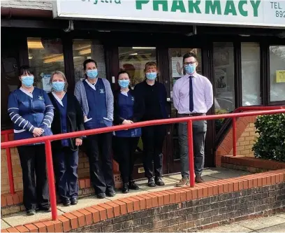  ??  ?? Staff outside Ty’r Felin Pharmacy on Cecil Road in Gorseinon, which has a new Atm-like system for collecting dispensed medicines from the pharmacy.