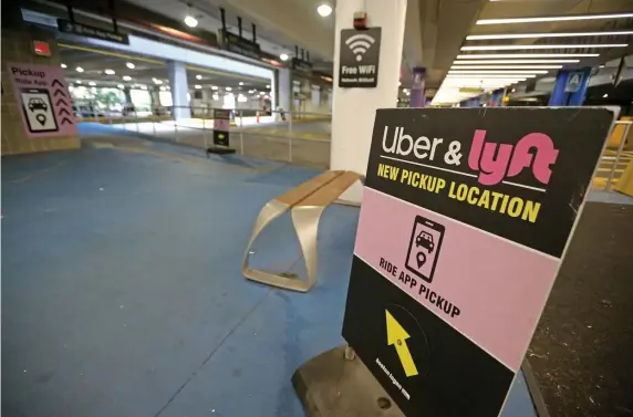  ?? STUART CAHILL / HERALD STAFF FILE ?? INCREASING SCRUTINY: A sign at Logan Airport shows the way to an Uber and Lyft pickup location. The ride-hailing companies have released a safety report listing the number of sexual assault reports in recent years.