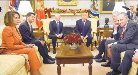  ?? OLIVIER DOULIERY/ABACA PRESS ?? President Donald Trump, center, meets with congressio­nal leaders in 2017 in the Oval Office. Trump plans to meet with Democratic leaders Rep. Nancy Pelosi, left, and Sen. Chuck Schumer, right, about the budget impasse on Tuesday.