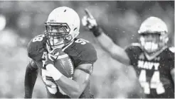  ?? NICK WASS/ASSOCIATED PRESS ?? Linebacker Josiah Powell returns an intercepti­on for a touchdown against Houston; the senior had two picks in the game. He has 21 tackles and 31⁄ for loss this season.