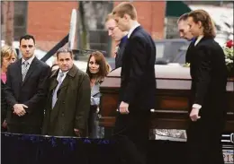  ?? Jim Michaud / Associated Press ?? In this Dec. 30, 2015, photo, Richard Dabate, left, watches the casket bearing his late wife Connie Dabate being carried during her funeral outside St. Bernard Roman Catholic Church in Vernon. While responding to a burglary alarm on Dec. 23, authoritie­s found Connie Dabate, mother of two children, shot to death and her husband Richard Dabate injured inside their home.