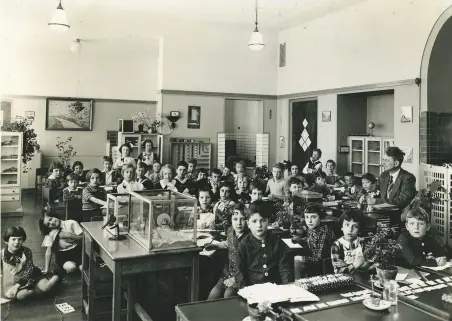  ??  ?? Class photo of Anne Frank (in center) at her Montessori school in Amsterdam, in 1936; opposite page, top, Eva Schloss; bottom, Anne Frank, age 11, in 1940; inset, Frank’s first diary; all Anne Frank photos courtesy Anne Frank House, Amsterdam