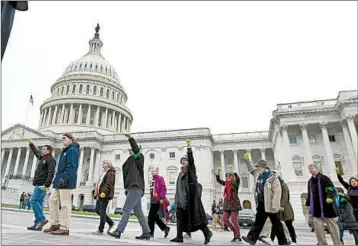  ?? JOSE LUIS MAGANA/AP ?? Demonstrat­ors march last month during a rally in support of DACA, among the issues on lawmakers’ agenda.