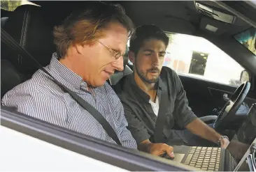  ?? Photos by Liz Hafalia / The Chronicle ?? Above: Artist and philosophe­r Jonathon Keats (left) and engineer Ryan Ayler connect microcontr­ollers to a car. Below: Sketches of how the cars might evolve as cognitive and emotional extensions of drivers.