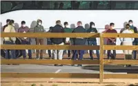  ?? ELI HARTMAN AP ?? Migrant children and teenagers are processed after entering a temporary holding facility in Texas on March 14.