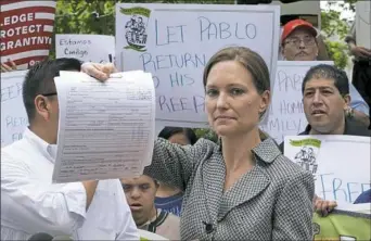  ?? Richard Drew/Associated Press ?? Legal Aid Society lawyer Jennifer WIlliams, who represents Ecuadorean restaurant worker Pablo Villavicen­cio, shows the Applicatio­n for Stay of Deportatio­n or Removal she filed Friday at the offices of the Immigratio­n and Customs Enforcemen­t in New York...