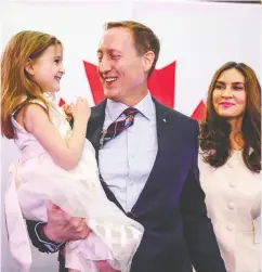  ?? DARREN CALABRESE / THE CANADIAN PRESS FILES ?? Peter Mackay holds his daughter Valentia as his wife Nazanin Afshin-jam looks on following Mackay’s official
launch for leader of the Conservati­ve Party of Canada.