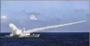  ?? ZHA CHUNMING / XINHUA ?? The Chinese missile frigate Yuncheng launches an anti-ship missile during a 2016 military exercise in the waters near south China's Hainan Island.