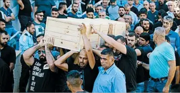  ?? ANCHO GOSH/EPA ?? Hail Sethawi’s coffin is carried Friday after the Israeli police officer was one of two killed in the Jerusalem shrine attack.