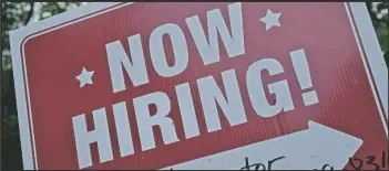  ?? MATT ROURKE ?? A “NOW HIRING” sign is posted in Garnet Valley, Pa., Monday, May 10, 2021. Applicatio­ns for unemployme­nt benefits inched down last week, Thursday, April 21, 2022, as the total number of Americans collecting aid fell to its lowest level in more than 50 years.