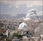  ?? AMMAR SULEIMAN/AFP ?? Smoke rises from buildings following an airstrike on the outskirts of Damascus on April 29.