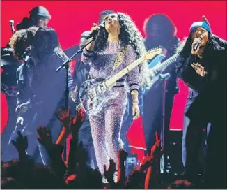  ?? Robert Gauthier Los Angeles Times ?? H.E.R. performs at the Grammys, where the singer won R&amp;B album for her self-titled work.