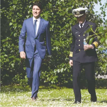  ?? THE CANADIAN PRESS ?? Prime Minister Justin Trudeau and commission­er of the Canadian Coast Guard Jeffery Hutchinson meet on Wednesday to announce the government’s plan to spend $15.7 billion on new ships, including two Arctic patrol vessels and 16 multi-purpose vessels.