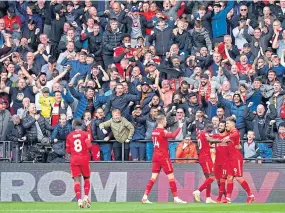  ?? ?? Liverpool players surround Robert Firmino, right