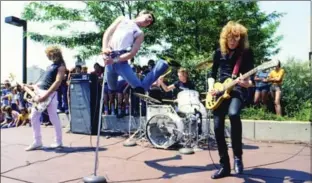  ?? WARNER CANADA ?? Teenage Head during the band’s heyday, performing on the Jackson Square rooftop. From left, Steve Mahon, Frankie "Venom" Kerr, Nick Stipanitz and Gord Lewis.