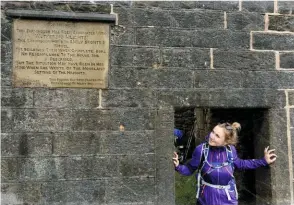  ??  ?? Hannah checks out the vintage plaque which rather grumpily tells you the truth about Top Withins “in response to many inquiries”. GETTING THE FACTS