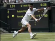  ?? TIM IRELAND — THE ASSOCIATED PRESS ?? Novak Djokovic returns to Adam Pavlasek on day four at Wimbledon in London Thursday.