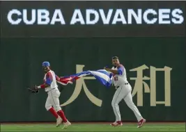  ?? EUGENE HOSHIKO — THE ASSOCIATED PRESS ?? Cuban players celebrate after defeating Australia in a World Baseball Classic quarterfin­al on Wednesday in Tokyo. Cuba plays a semifinal game tonight in Miami.