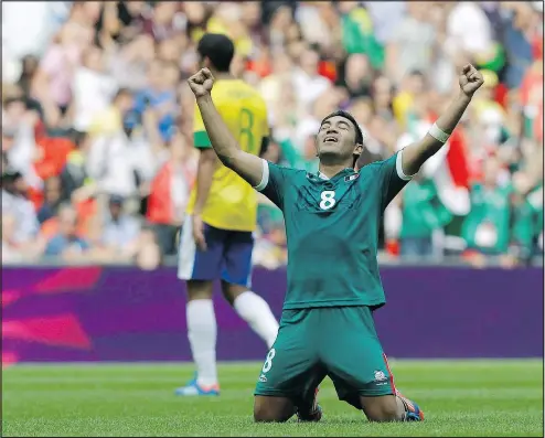  ?? HASSAN AMMAR/AP ?? Mexico’s Marco Fabian reacts as Brazil’s Romulo walks off the field during the men’s soccer final at the 2012 Summer Olympics in London. Mexico’s World Cup entry has seven players from that gold-medal winning team.