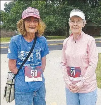  ?? Westside Eagle Observer/SUSAN HOLLAND ?? Susan Hazard and her friend Ruth Poemoceah pause for a photo just before the start of the Gravette Day 5K. Poemoceah travels to Rogers to walk with Susan once a week and asked if she would like to join her in the race. Susan readily accepted.