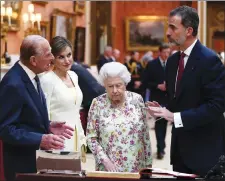  ?? AP PHOTO ?? Britain’s Queen Elizabeth II and Prince Philip stand with Spain’s King Felipe, right, and Queen Letizia, second right, next to a display of Spanish items from the Royal Collection at Buckingham Palace yesterday.