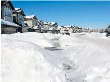  ?? GAVIN YOUNG ?? Snow remains piled along a street in the Skyview Ranch neighbourh­ood. Some areas might experience flooding as the snow melts.