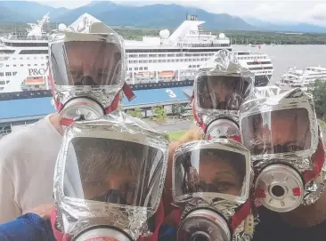  ??  ?? SMOKING ZONE: Belinda Peck and her neighbours don firefighte­rs' masks as smoke wafts into their Piermonde Apartments from a cruise ship docked at the Cairns Cruise Liner Terminal. Picture: SUPPLIED