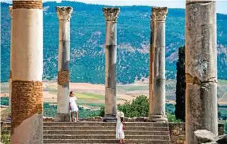  ?? — AFP photos ?? Photos shows tourists walk through the ruins of the ancient Roman site of Volubilis, near the town of Moulay Idriss Zerhounon in Morocco’s north central Meknes region.
