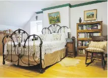  ??  ?? Above the double bed with its intricate forged aluminum headboard and footboard, hangs a landscape scene painted by Joel Gerber’s uncle.