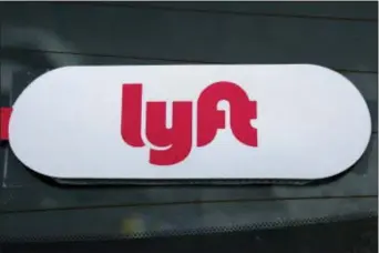  ?? GENE J. PUSKAR — THE ASSOCIATED PRESS FILE ?? This file photo shows a Lyft logo on a Lyft driver’s car in Pittsburgh. Lyft officially kicked off the road show for its initial public offering Monday with 30 million shares expected to cost between $62 and $68 per share.