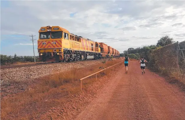  ??  ?? TRAINING: Ross Dawson and Anna Drum run along Andoom Road ahead of the first Weipa Running Festival on Sunday.