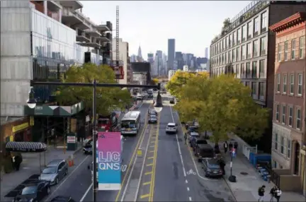  ?? MARK LENNIHAN — ASSOCIATED PRESS ?? Traffic moves along 44th Drive in the Long Island City section of Queens on Wednesday, Nov. 7. Amazon plans to bring 25,000 jobs there.