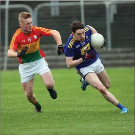  ??  ?? Conor Byrne of Wicklow is chased by Liam Roberts of Carlow during their O’Byrne Cup game at Netwatch Cullen Park.