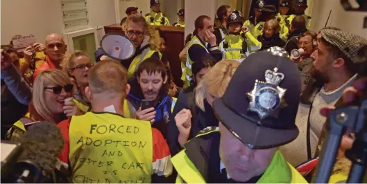  ??  ?? Chaos: Far-Right protesters and police officers outside Attorney General Geoffrey Cox’s office in Westminste­r yesterday