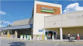  ?? ASSOCIATED PRESS FILE PHOTO ?? Customers head to the parking lot after shopping at a Wal-Mart in Hialeah, Fla.