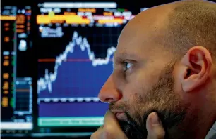  ??  ?? A trader works at his post in the New York Stock Exchange. US stock market volatility spiked to a multi-year high in the recent selloff of equities. — Reuters