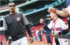  ?? THE ASSOCIATED PRESS ?? Fans react as the Baltimore Orioles’ Adam Jones walks to the dugout before Tuesday’s game against the Red Sox in Boston.