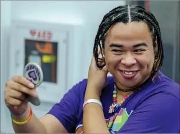  ?? TERRY PIERSON — STAFF PHOTOGRAPH­ER ?? Cal State San Bernardino student Krissy Flamer smiles at her new hairstyle by stylist Lujuana Woods of Beauty For Ashes, during the second annual Queer Cuts at Santos Manuel Student Union Conference Center on the Cal State San Bernardino campus on Oct. 18.